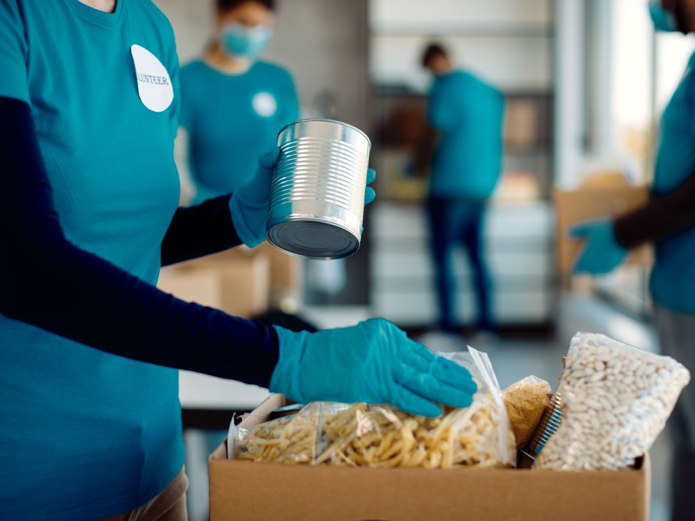 Volunteers packing dry goods and canned food into boxes